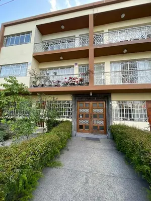 an apartment building with a door and a balcony at Céntrico Dpto Puca Lima a 2 cuadras de Hospital Rebagliati y Real Plaza Salaverry in Lima
