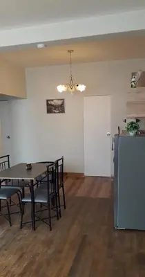 a dining room with a table and chairs and a refrigerator at Mica&Tory in Cusco