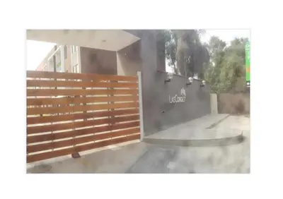 a wooden fence in front of a building at Lascondes in Chosica