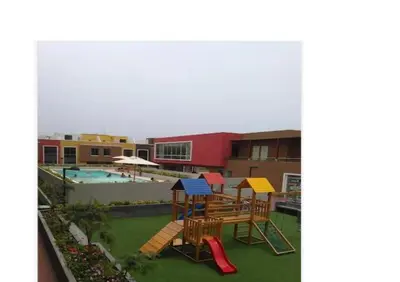 a playground with colorful chairs and a swimming pool at Lascondes in Chosica