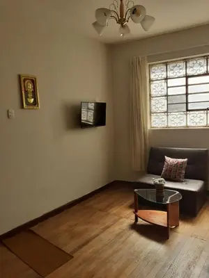 a living room with a couch and a table at Cozy loft in the heart of the city in Cusco