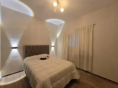 a bedroom with a bed and a window with curtains at Cozy loft in the heart of the city in Cusco