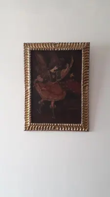 a framed painting of a woman with a pizza at Cozy loft in the heart of the city in Cusco