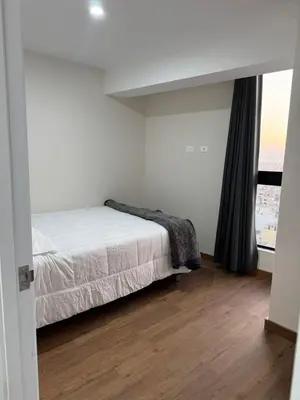 a white bedroom with a bed and a window at 2-Bedroom Apt, Perfect for Family or Work Stays in Lima