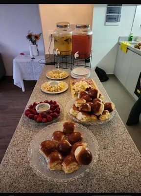 a table topped with different types of pastries and drinks at 2-Bedroom Apt, Perfect for Family or Work Stays in Lima