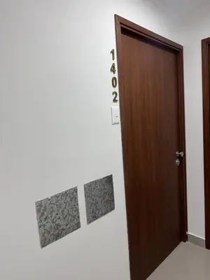 a wooden door in a room with a white wall at 2-Bedroom Apt, Perfect for Family or Work Stays in Lima