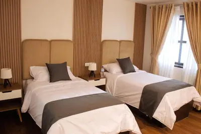 a hotel room with two beds and a window at Barón de Huaura Hotel Boutique in Huaura