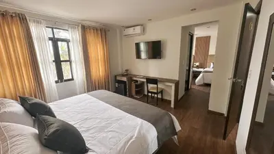 a hotel room with a bed and a desk in it at Barón de Huaura Hotel Boutique in Huaura