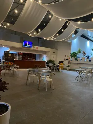 a large room with tables and chairs and a tv at Casa Grau Chincha in Chincha