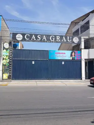 a blue fence in front of a building with a sign at Casa Grau Chincha in Chincha
