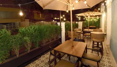a restaurant with tables and chairs and an umbrella at Casa Atempo Boutique Hotel in Lima