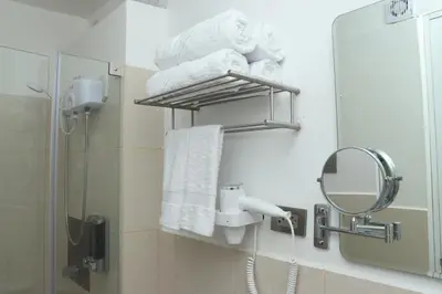 a bathroom with a towel rack and a mirror at Casa Atempo Boutique Hotel in Lima