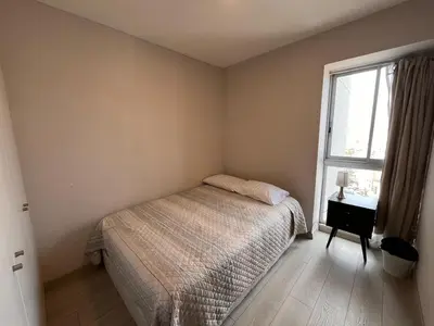 a small bedroom with a bed and a window at Departamento Salaverry in Lima