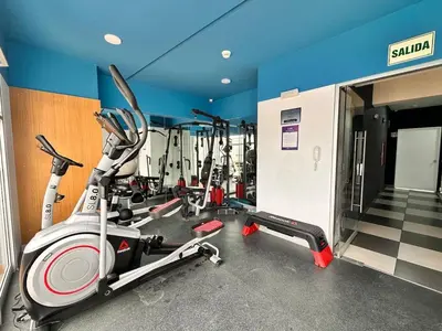 a gym with a bunch of treadmills and machines at Departamento Salaverry in Lima
