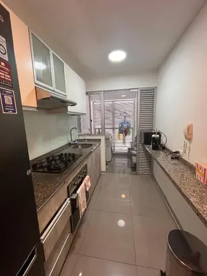 a kitchen with a sink and a stove top oven at Departamento Salaverry in Lima