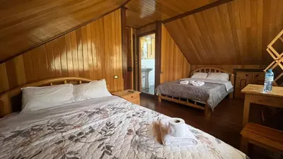 a bedroom with a bed with a roll of toilet paper on it at CABAÑAS RANCH OXaPAMP4 in Oxapampa