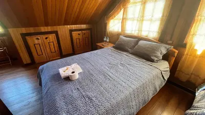 a room with a bed with a towel on it at CABAÑAS RANCH OXaPAMP4 in Oxapampa