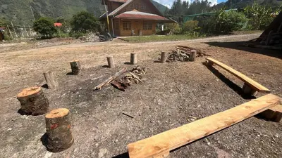a group of logs and sticks on a dirt field at CABAÑAS RANCH OXaPAMP4 in Oxapampa