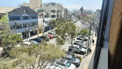 a view from a window of a parking lot with cars at Lima Family Lodge Apartment near Miraflores Center in Lima