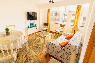 a living room with a couch and a table at Lima Family Lodge Apartment near Miraflores Center in Lima