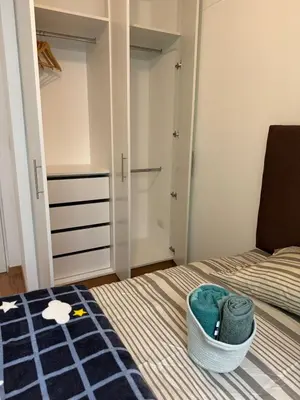 a small bedroom with a bed and a closet at TyB apartment in Lima