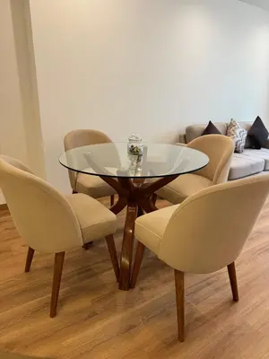 a glass table and chairs in a room with a couch at TyB apartment in Lima
