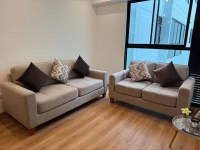 a living room with a couch and a chair at TyB apartment in Lima