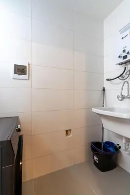 a white bathroom with a sink and a counter at Solar Breezy Retreat by Geko in Lima