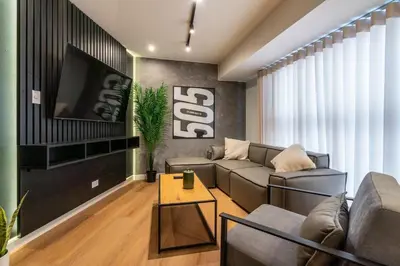 a living room with a couch and a tv at Solar Breezy Retreat by Geko in Lima