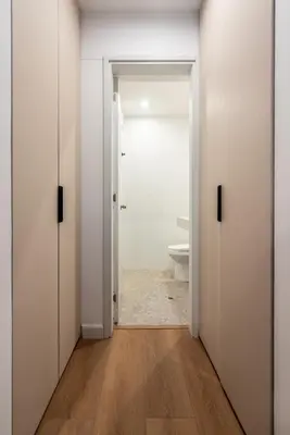 a bathroom with white doors and a toilet at Solar Breezy Retreat by Geko in Lima