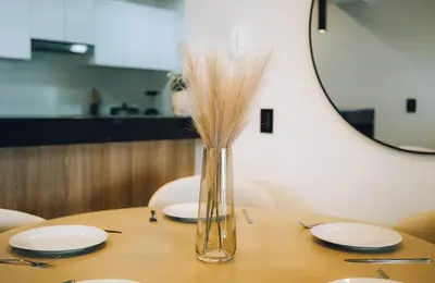 a vase filled with dry grass sitting on a table at Luxurious Apartment in the heart of Miraflores in Lima