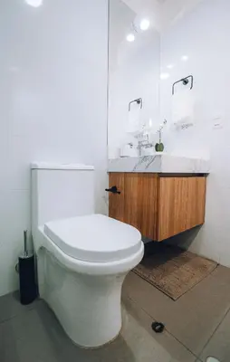 a white bathroom with a toilet and a sink at Luxurious Apartment in the heart of Miraflores in Lima