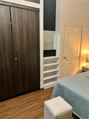 a bedroom with a bed and a closet and a stairs at Private Whole Apartment in Surco close to Barranco in Lima
