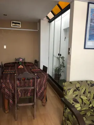 a room with a table and a chair and a window at Departamento familiar Lucrepata in Cusco
