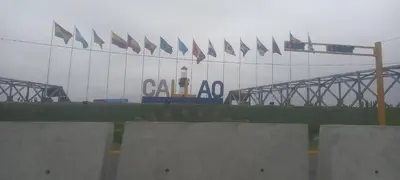a group of flags on a building with a lighthouse at IN FRONT OF THE NEW AIRPORT Hospedaje - A y C Taxi Free - Airport - Apartment on the 1st Floor in Lima