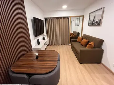 a living room with a couch and a table at Apartamento Amoblado a un paso del parque de las aguas in Lima