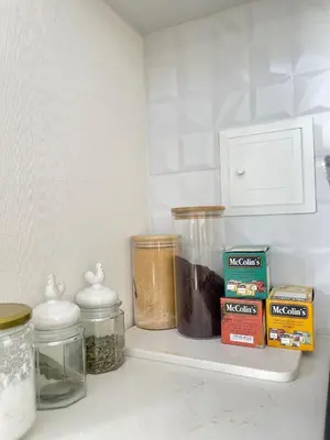 a shelf with spices and jars on it in a kitchen at LimaeStays Exclusive penthouse in downtown Barranco in Lima