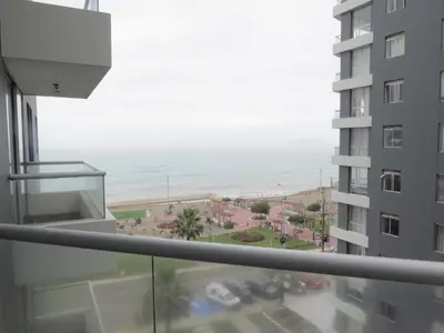 a view of the ocean from the balcony of a building at Panoramic View in Lima