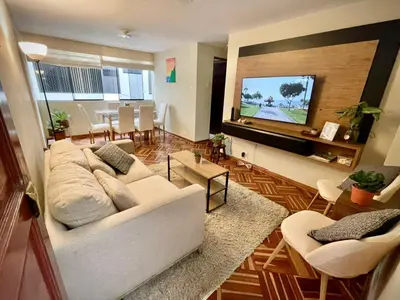 a living room with a white couch and a flat screen tv at Close to the beach, Big beds, Malecon Miraflores in Lima