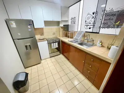 a small kitchen with a refrigerator and a sink at Close to the beach, Big beds, Malecon Miraflores in Lima