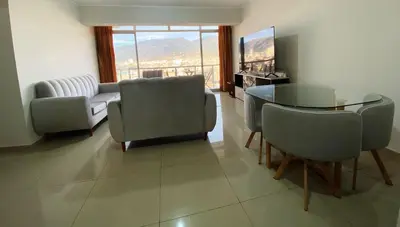 a living room with a couch and a table and chairs at Apartment in downtown Huancayo in Huancayo