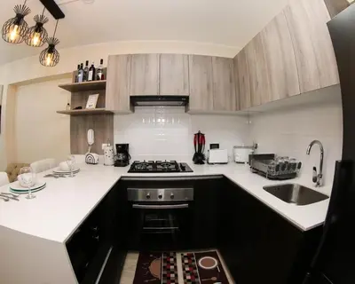 a kitchen with a sink and a stove top oven at Nice Department Full Equip in Barranco - Gym, Pool in Lima