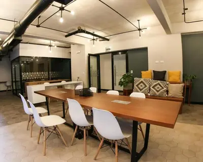 a conference room with a wooden table and white chairs at Nice Department Full Equip in Barranco - Gym, Pool in Lima