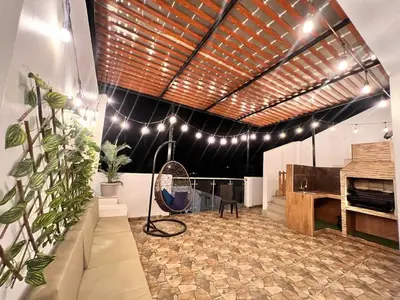 a living room with a table and a fireplace at Casa Rosé Vacacional in Santa Rosa