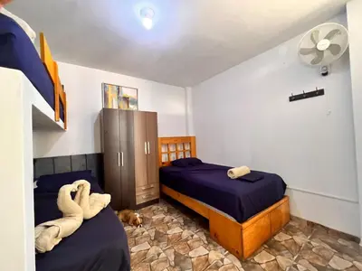 a bedroom with two beds and a dog laying on the floor at Casa Rosé Vacacional in Santa Rosa