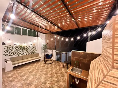 a room with a bar with lights on the ceiling at Casa Rosé Vacacional in Santa Rosa