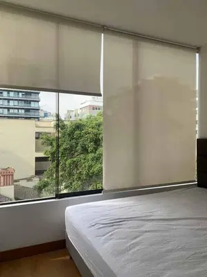 a bedroom with a bed and a large window at Ocean View Nice and cozy in Lima