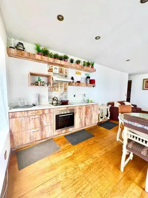 a kitchen with a wooden counter top and a table at Ocean View Nice and cozy in Lima
