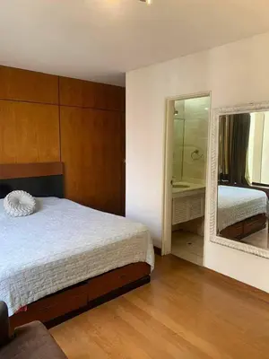 a bedroom with a bed and a large mirror at Ocean View Nice and cozy in Lima