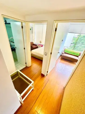 a living room with a view of a room with a mirror at Ocean View Nice and cozy in Lima